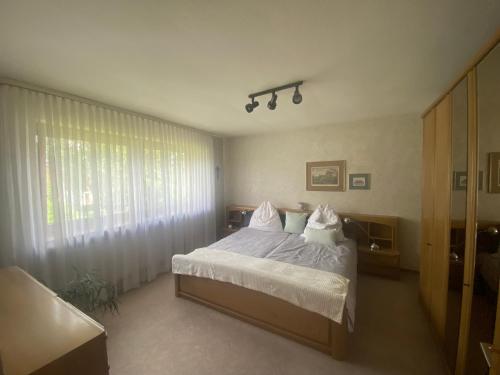 a bedroom with a bed with white sheets and pillows at Haus Gert in Mellrichstadt