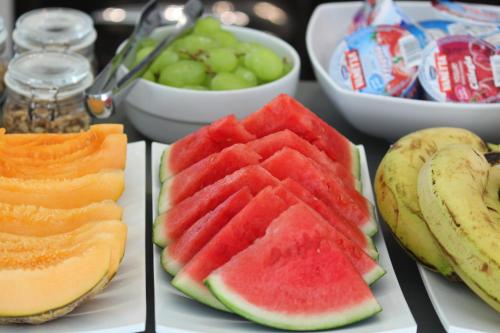 a bunch of different types of fruit on plates at Hotel Riva e Mare in Rimini