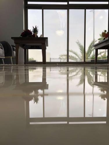 an empty room with a table and a reflection in the floor at YM Resort in Yanbu