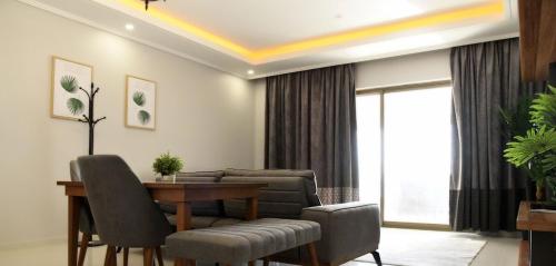 a living room with a table and a couch at YM Resort in Yanbu