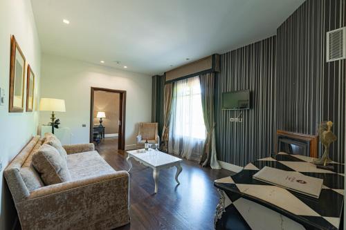 a living room with a couch and a table at Nymfasia Resort in Vytina