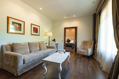 a living room with a couch and a table at Nymfasia Resort in Vytina