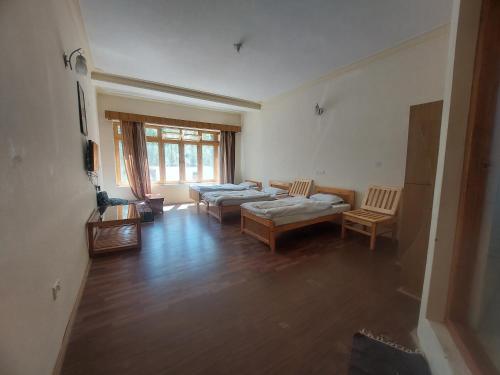 a living room with two couches and a tv at Smanla guest house in Leh