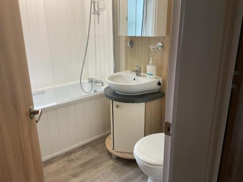 a bathroom with a sink and a toilet at Nodes Point Sandy Bay AP27 affordable ferry prices available in Saint Helens