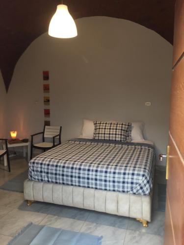 um quarto com uma cama com um cobertor xadrez em Helios Arabians no Cairo
