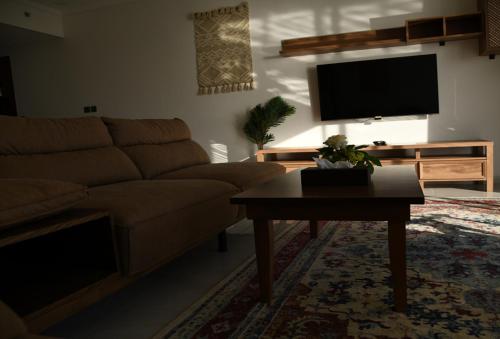 a living room with a couch and a coffee table at YM Resort in Yanbu