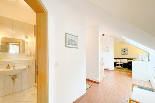 a bathroom with a sink and a toilet in a room at Maria Gabriele Karlstrasse 6b Ferienwohnung 12 in Kolpinsee