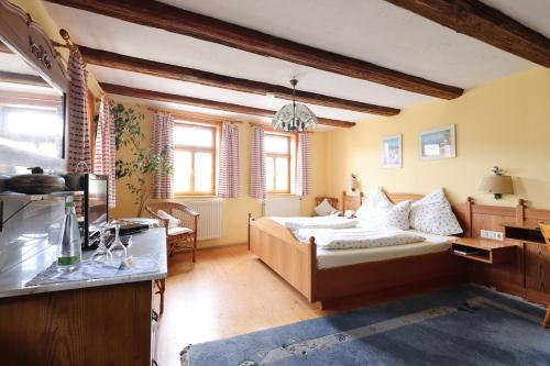 a bedroom with a bed and a desk in it at Hotel-Gasthof-Schiff in Winterhausen