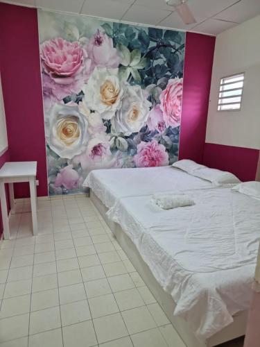 a bedroom with a flower mural on the wall at LeCOMFY GUESTHOUSE HOMESTAY TAMBUN IPOH with UNIFI, NETFLIX,AIRCOND in Ipoh
