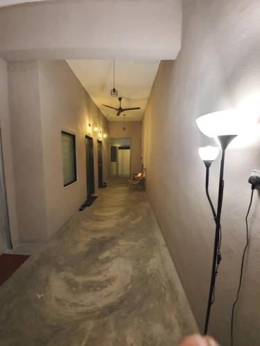 an empty hallway with two lights on a wall at Wayton Express in George Town