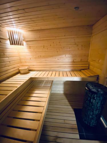 a wooden sauna with a bench in the middle at Psí bouda Benecko in Benecko