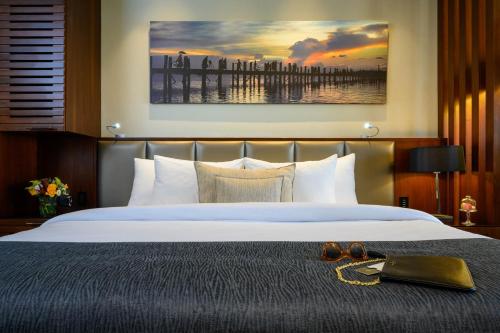 a bed with a pair of shoes on top of it at Carlton Tel Aviv Hotel – Luxury on the Beach in Tel Aviv