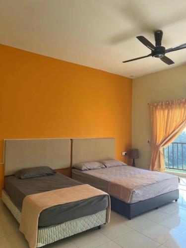 a bedroom with two beds and a ceiling fan at Studio 7 Gold Coast Morib Resort in Banting