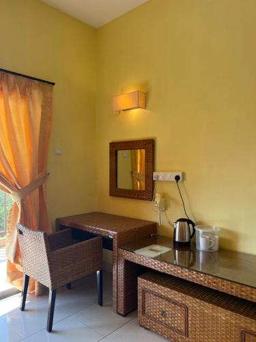 a room with a table and a mirror and a chair at Studio 6 Gold Coast Morib Resort in Banting