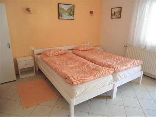 a bedroom with two beds with orange sheets at Apartma Gorjan in Tolmin