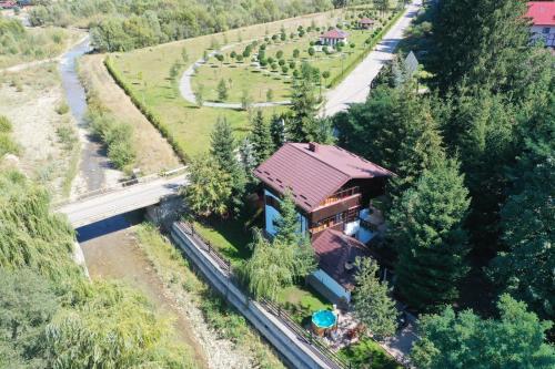 an aerial view of a house with a train station at Cabana Gura Voronețului in Gura Humorului
