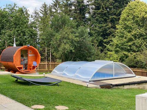 a tent and a hammock in a yard at Wellness chata Kozička in Klokočov