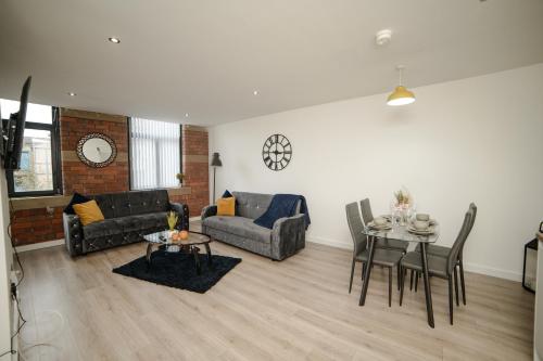 a living room with a couch and a table at Bv Luxury Apartment Conditioning House in Bradford