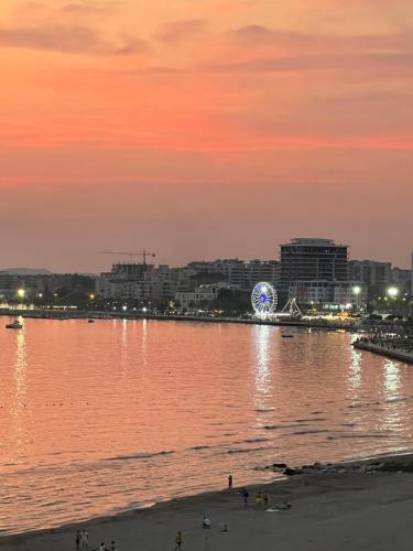 a large body of water with a city in the background at Marina Premium Hotel & Apartments in Vlorë