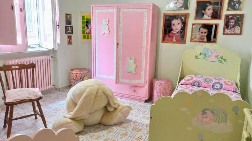 a childs bedroom with a stuffed animal in the floor at The Secret Garden Maratea - Casa di Sery in Maratea