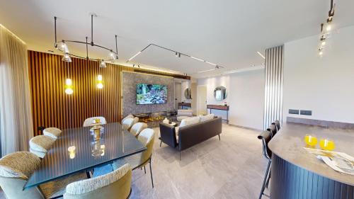 a living room with a dining table and a couch at KING DAVID RESIDENCES - Pool & Gym in Jerusalem