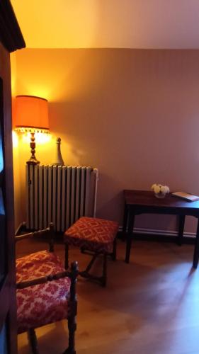 a living room with a radiator and a chair and a lamp at MAISON ALETEIA*** DECOUVERTE ET SERENITE in Alet-les-Bains