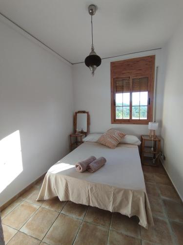 a bedroom with a bed with two towels on it at AMIRA home near Sitges in Sant Pere de Ribes