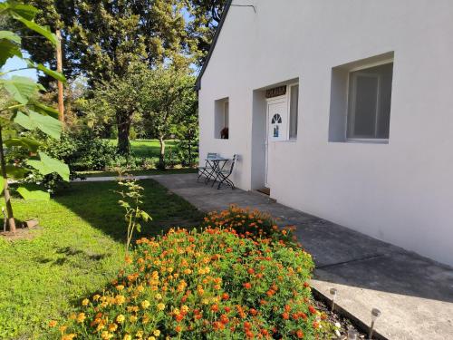 a white house with a garden with flowers at Caesar Residence in Budapest