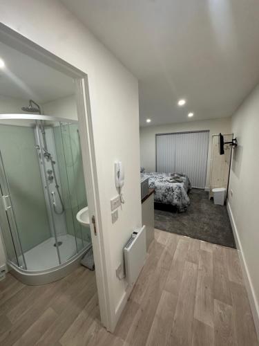 a bathroom with a shower and a bed in a room at Selborne studios - Breakfast Included in Parkside