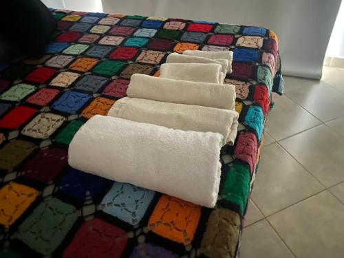 a colorful bed with towels on top of it at Departamento 3 centro - Cardiológico con cochera in Corrientes