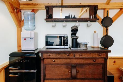 a kitchen with a counter with a coffee maker and a microwave at Battenkill Glamping Resort in Cambridge