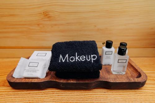a wooden tray with two bottles of makeup on it at Battenkill Glamping Resort in Cambridge