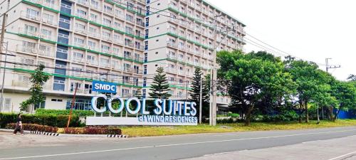 a sign in front of a large apartment building at The Happy Home at Smdc Cool Suites Wind Residences in Tagaytay
