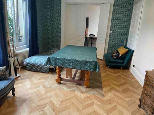 a dining room with a table and a chair at Appartement de caractère in Mirecourt