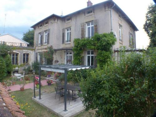 a house with a picnic table in front of it at Appartement de caractère in Mirecourt