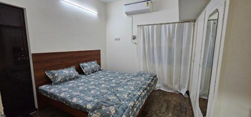 a small bedroom with a bed and a window at HOMESTAY - AC 3 BHK NEAR AlRPORT in Chennai