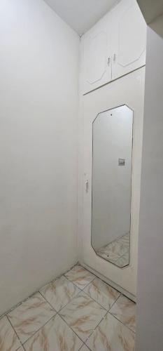 a white room with a mirror and a tiled floor at HOMESTAY - AC 3 BHK NEAR AlRPORT in Chennai