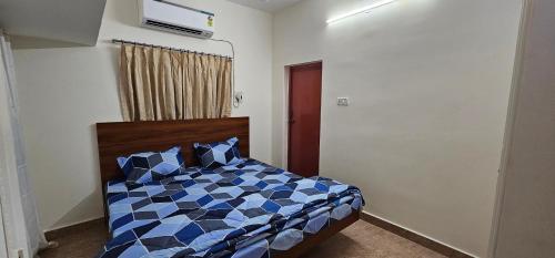 a bedroom with a bed with blue and white at HOMESTAY - AC 3 BHK NEAR AlRPORT in Chennai