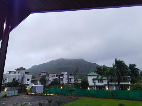 a view of a mountain from a house at Sky Lawns in Lonavala