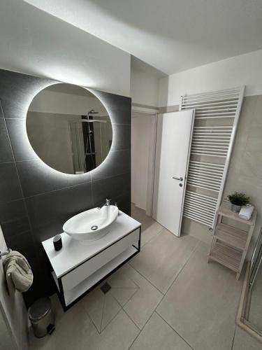 a bathroom with a white sink and a mirror at @trstenik in Trstenik