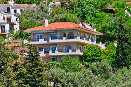 a house on the side of a hill with trees at Endless green 1 Arethousa Ikaria in Arethousa