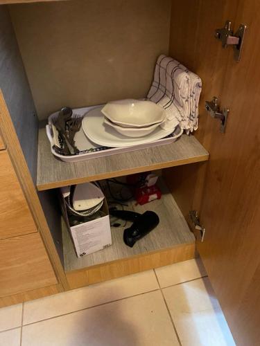 a cabinet with a plate on a shelf with a plate at Valletta Private Room in Valletta