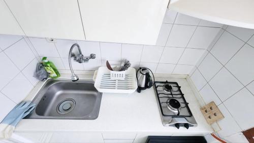 a small kitchen with a sink and a stove at The house of gallery in Daegu