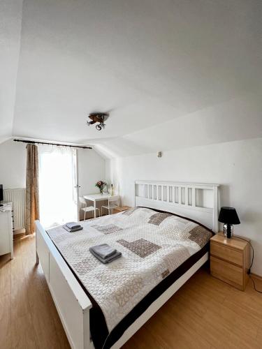 a white bedroom with a large bed in a room at Penzion Sofi in Prague