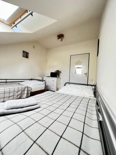 a room with two beds and a mirror on the wall at Penzion Sofi in Prague