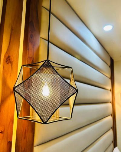 a glass light hanging from a ceiling at Hotel Balgopal in Kathmandu