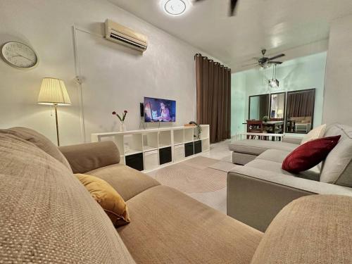 a living room with a couch and a tv at Homestay Mijanna in Johor Bahru