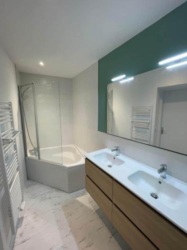 une salle de bain avec une baignoire, un lavabo et une douche dans l'établissement LE CHOUCAS - LA MONGIE, à Bagnères-de-Bigorre