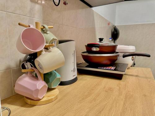 a kitchen counter with various appliances on a counter top at Mijanna Guesthouse - Johor Bahru in Johor Bahru