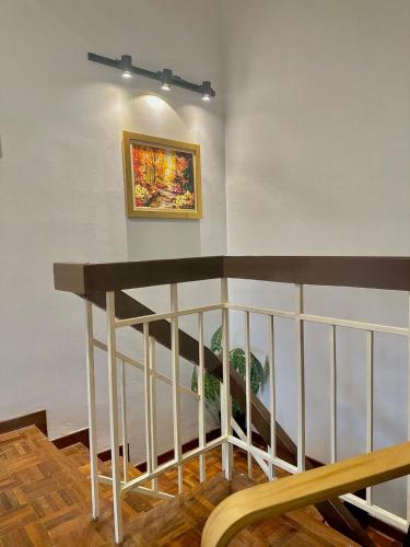 a painting on a wall next to a stair case at Mijanna Guesthouse - Johor Bahru in Johor Bahru